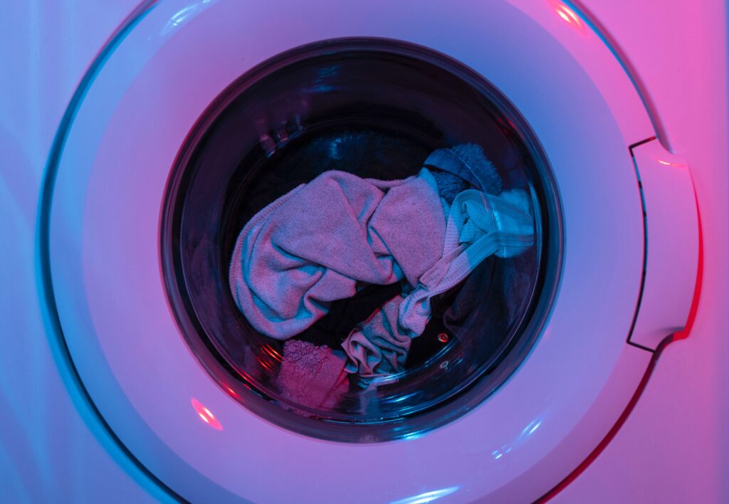 A modern Samsung washing machine in a well-lit laundry room, showcasing advanced technology and convenience.