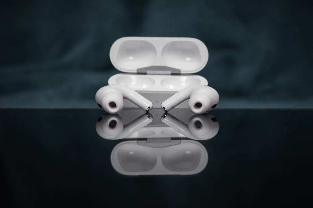 Illustration of AirPods and a charging case, showcasing the reset process.